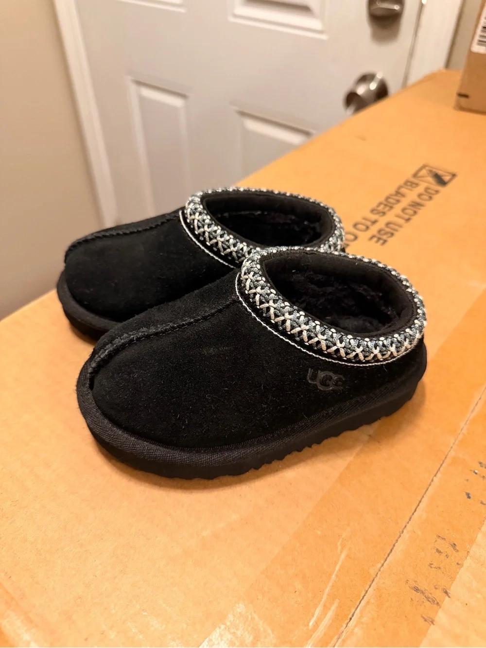 UGG Toddlers Black Suede Slip-On Slippers with Woven Collar